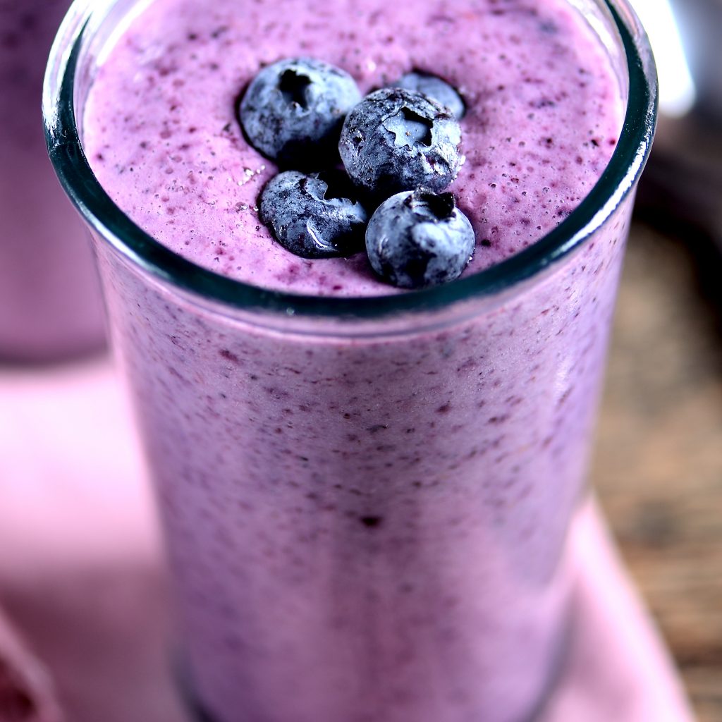 Protein smoothie of yogurt, milk, honey and blueberries.