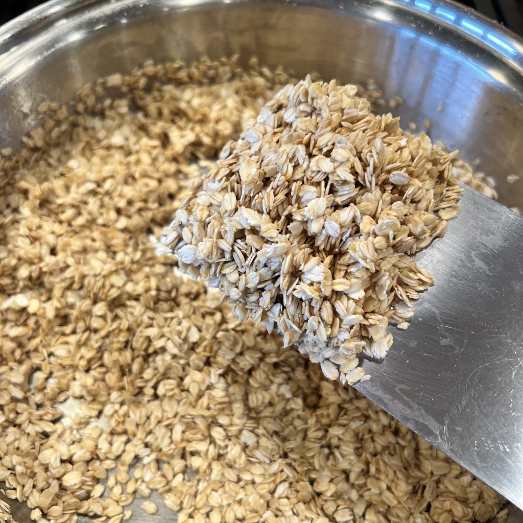 toasted gluten free rolled oats on a spatula