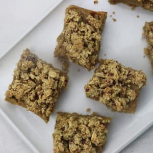 Gluten-Free Apple Cranberry Crumble Protein Bars on a white plate, ready to serve.