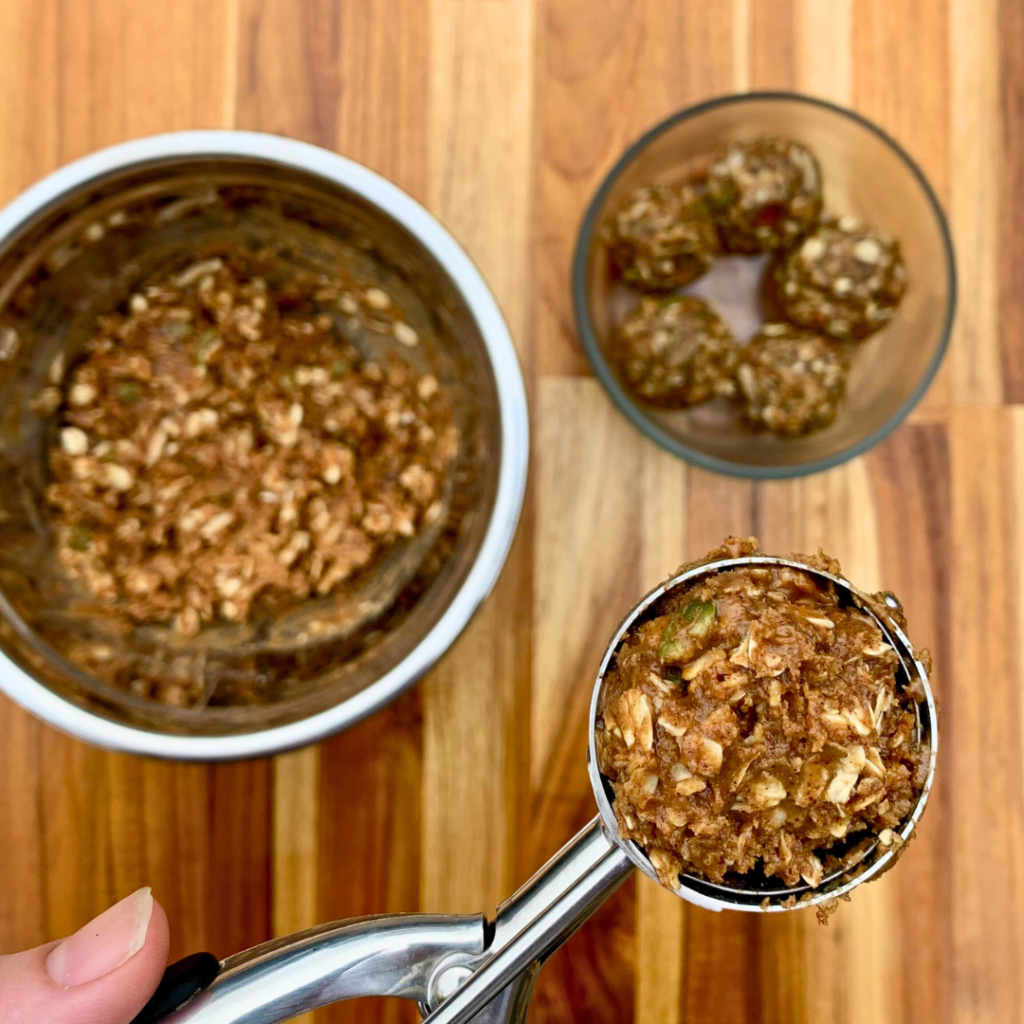 Using a cookie scoop to portion the nut-free muesli mixture.