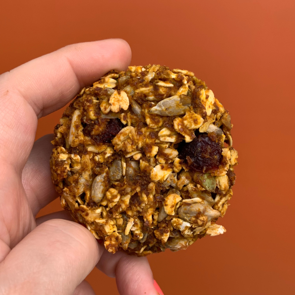 close up of a breakfast cookie with wholesome ingredients such as seeds, organic oats, and dried fruit.