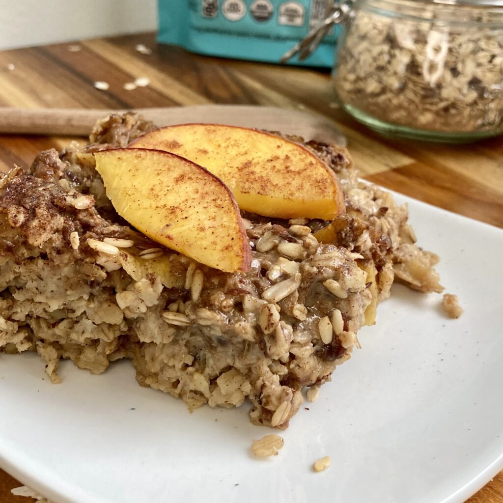 A warm piece of peach baked superfood oatmeal with cinnamon and spice.